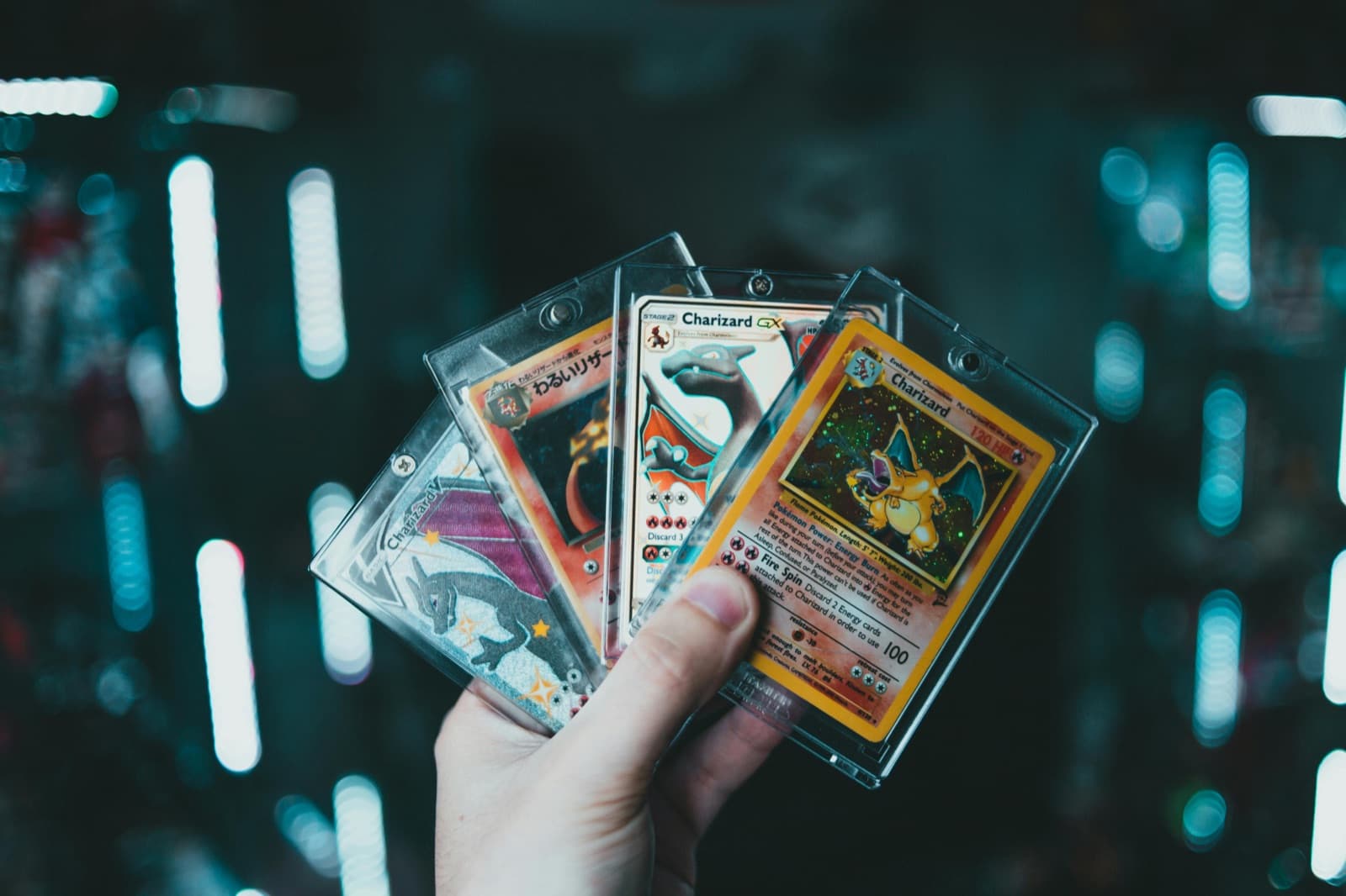 Cartes Pokémon Charizard tenues en main